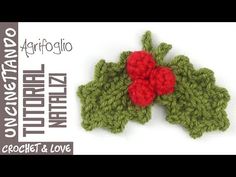 a crochet pattern for a holly ornament with two red berries on it