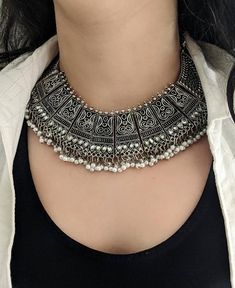 Add charm and charisma to your beautiful personality with these stunningly handcrafted high quality German silver chokers and matching earrings. Wear it with any of your formal or casual outfits and grab compliments all the way!Length of the metal part in the choker is 9 inchesDrop length from top to bottom ,9 inches approx Length adjustableLength of earrings 2 inches approxWeight of the choker is 105 gm approxColour : AntiqueNote: All in stock items will be shipped from New Delhi, India within Rajasthani Jewellery Traditional Silver, Choker Necklace Designs Silver, Rajasthani Silver Jewellery, Oxidised Jewellery With Kurti, Silver Necklaces Indian, Silver Choker Necklace Indian, Antique Silver Jewelry Necklace, Silver Antique Jewelry, Black Metal Necklace