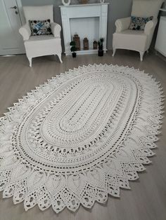 a white crocheted rug on the floor in a living room