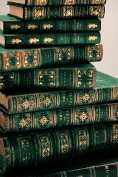 a stack of green books sitting on top of each other