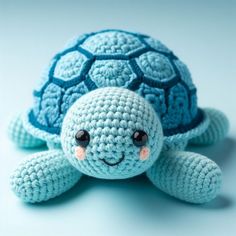 a blue crocheted turtle sitting on top of a table