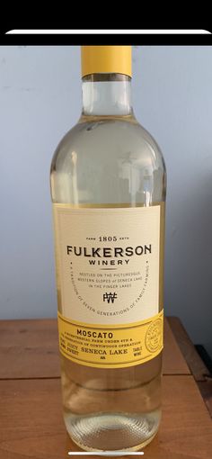 a bottle of water sitting on top of a wooden table