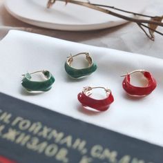 [MATERIAL]: Brass with enamel. [HOOP SIZE]: 20mm or 0.78" Green Enamel Hoop Jewelry, Small Hoop Red Earrings For Everyday, Red Small Hoop Earrings For Everyday, Small Red Hoop Earrings For Everyday Wear, Green Enamel Hoop Earrings, Red Enamel Round Earrings, Red Enamel Trendy Earrings, Red Round Enamel Earrings, Trendy Enamel Earrings For Everyday