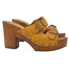 Bring color to your outfits with our ocher clogs! With a warm and bright tone, they are ready to become the top element of your wardrobe! Women's clogs with brown wood effect base Upper in ocher leather, with decorative buckles Padded leather insole Heel height 8.5 cm + 3 cm plateau Comfortable and light Made entirely by specialized Italian personnel Handcrafted products using the best materials. BEFORE PURCHASING DO NOT FORGET TO CHECK THE SIZE! Brown Wedge Heel Clogs With Buckle Closure, Yellow Platform Clogs With Round Toe, Casual High Heel Clogs With Buckle Closure, Yellow Leather Sandals With Wooden Heel, Yellow Leather Mules With Wooden Heel, Yellow Platform Clogs, Closed Toe Sandals With Wooden Heel For Fall, Fall Wooden Heel Closed Toe Sandals, Yellow Clogs With Wooden Heel And Round Toe