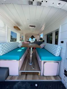 the inside of a camper with two couches and tables on top of it