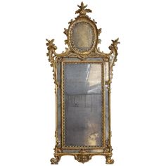 an ornate gold framed mirror on a white background