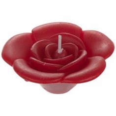 a red candle that is shaped like a flower