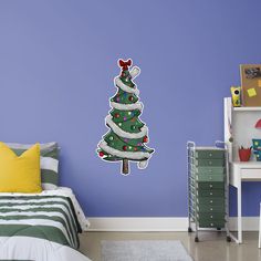 a bedroom with a christmas tree decal on the wall