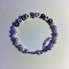 a bracelet with beads and letters on it