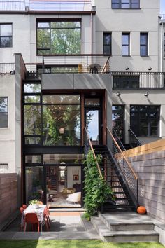 an outdoor living area with stairs leading to the upper floor