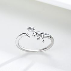 Embrace the fusion of prehistoric charm and modern elegance with our Sterling Silver Open Dinosaur Ring for Women, exquisitely plated in white gold to offer a timeless yet playful accessory for any occasion. Crafted with meticulous attention to detail, this unique open ring features a dinosaur design, symbolizing strength and adventure. Made from highquality sterling silver and enhanced with a pristine white gold plating, this nostone piece ensures durability and a luxurious feel, making it a ve Dinosaur Ring, Dinosaur Pendant, Sunflower Ring, Sterling Silver Anklet, Clover Earrings, Silver Shop, Kids Necklace, Agate Jewelry, Jade Jewelry