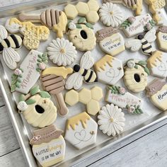 decorated cookies in the shape of honeycombs and beehives on a tray