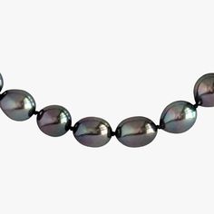 This Tahitian Pearl necklace is truly exceptional in its quality and beauty. With an oval clasp made of 14K white gold, this necklace is a timeless piece that will be cherished for generations. The necklace is 18 inches in length and weighs 47.6 grams. The pearls are cultured Tahitian pearls, with shades of Purple, Cherry, and Green Cherry that are absolutely breathtaking. The pearls vary in size from 8.5-10.0mm in width and 10-14mm in length, and they are semi-round, oval, and drop-shaped. The Green Cherries, Tahitian Pearl Necklace, Pearl Strands, Tahitian Pearls, Shades Of Purple, Timeless Pieces, Timeless Elegance, Pearl Necklace, Cherry