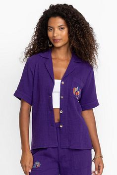 Crafted from 100% breathable cotton, the Desire Camp Shirt is embellished with intricate colorful embroidery at the front and back. Featuring a classic collared button-front, this relaxed-fit casual shirt is finished with a patch pocket at the chest. Pair with linen shorts and strappy sandals for a vibrant weekend look. Johnny Was Women's Camp Shirt in Violet Indigo Purple, Size Small, Linen/Cotton Summer Embroidered Button-up Camp Shirt, Embroidered Button-up Camp Shirt For Summer, Casual Collared Camp Shirt With Floral Embroidery, Casual Floral Embroidered Collared Camp Shirt, Casual Tops With Floral Embroidery And Spread Collar, Casual Floral Embroidery Tops With Spread Collar, Summer Floral Embroidered Collared Camp Shirt, Summer Floral Embroidered Top With Spread Collar, Summer Top With Floral Embroidery And Spread Collar