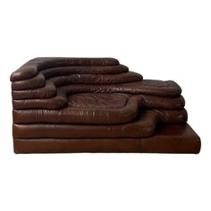 a stack of brown leather couches sitting on top of each other