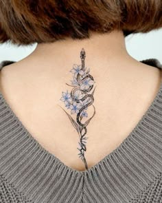 a woman with a tattoo on her back neck