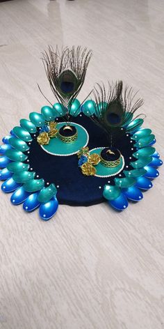 two peacocks are sitting on top of a blue platter with gold trimming