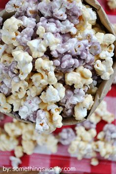 a bag full of popcorn sitting on top of a red and white checkered table cloth