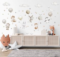 an animal themed nursery room with balloons and stars on the wall, including a fox