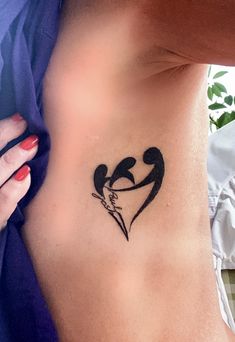 a woman with a tattoo on her stomach that says love is in the air and two hearts