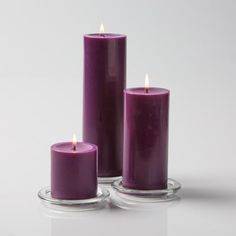 three purple candles sitting next to each other