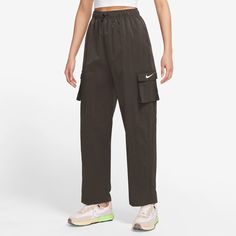 Dress up in the utilitarian style of the Nike Essential Woven HR Cargo Pants. Crafted with lightweight woven fabric with a soft and semi-structured feel, these pants keep you comfortable and relaxed no matter what. Featuring a high-rise fit that hits at the belly button, these pants are the perfect pair for your favorite cropped and oversized tops. Sporting an open hem for a casual fit and an embroidered Swoosh on the left cargo pocket, the Nike Essential Woven HR Cargo Pants instantly spruce up Women Sailing, Oversized Tops, Nike High, Utilitarian Style, Cargo Pocket, Oversized Top, Cargo Pants Women, Cargo Trousers, Casual Fit