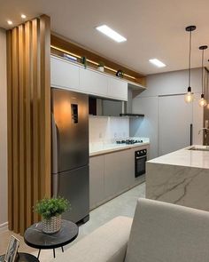 a modern kitchen with marble counter tops and stainless steel appliances