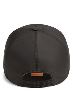 Gilt logo lettering brands this classic six-panel baseball cap crafted of techical fabric with a cotton lining to ensure maximum breathability. Cotton lining 100% polyester Spot clean Made in Italy Black Baseball Cap For Travel, Black Trucker Hat Baseball Cap For Travel, Black Snapback Hat With Curved Brim For Travel, Black Curved Brim Snapback Hat For Travel, Modern Black Outdoor Hat, Waterproof Black Nylon Hats, Functional Black Baseball Cap With Curved Visor, Black Waterproof Visor Hat, Luxury Men's Baseball Cap With Logo