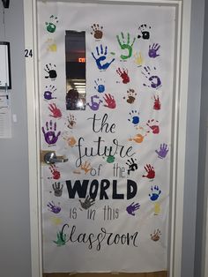 a door decorated with handprints and the words, the future is in this classroom