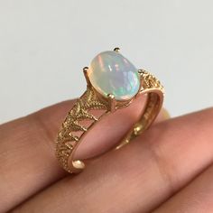 RING DETAILS: ✪Design: Gold ring ✪Gemstone: Opal ✪Gemstone shape: Oval ✪Gemstone transparency: Transparent ✪Gemstone size: 7mm*9mm ✪Gemstone weight: 1.45 cts. ✪Setting type: Prong setting ✪Metal type: 14k yellow gold ✪Metal finish: Smooth shiny Choose your ring size from drop down menu and if you need any other preferred ring size please contact us. QUALITY OF MATERIALS: Metal: Most of our jewelry at JewelryMansion is made with precious metals like gold and silver. These metals are 100% non-alle Ethiopian Opal Gemstone Ring For Anniversary, 14k Gold Oval Cabochon Opal Ring For Anniversary, Ethiopian Opal Oval Rings For Anniversary, Oval Ethiopian Opal Birthstone Ring, Ethiopian Opal Ring For Anniversary, Ethiopian Opal Birthstone Rings, Anniversary Ethiopian Opal Round Ring, 14k Gold Opal Gemstone Ring For Anniversary, Gold Opal Ring With Accent Stones