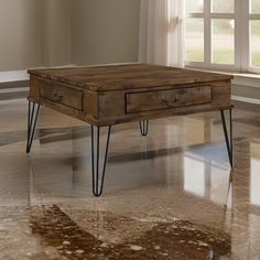 a coffee table with hairpin legs in front of a window on a marble floor