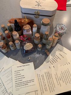 an assortment of spices and condiments sitting on top of a table next to papers