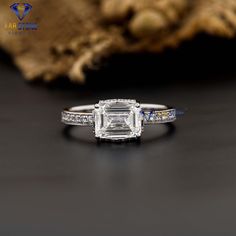 an emerald cut engagement ring with side stones