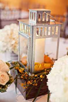 a table with flowers and candles on it