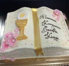 a cake decorated with an open bible and flowers