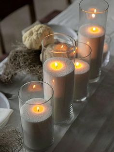 four candles are lit on a table