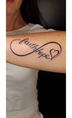 a woman with a tattoo on her arm that says faith hope and hearts in cursive writing