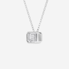 A very modern update to the classic bezel set solitaire,  this one features and east-west design, meaning that the diamond is suspended sideways on the neck.  Set with an elegant emerald cut lab grown diamond this one is sure to grab compliments! White Asscher Cut Jewelry With Bezel Setting, Modern Octagon Jewelry With Bezel Setting, Classic Solitaire Necklace With Smooth Bezel For Formal Occasions, Modern Solitaire Diamond Cut Necklace For Anniversary, Modern Solitaire Diamond Necklace For Anniversary, Timeless Solitaire Necklace With Bezel Setting For Formal Occasions, Timeless Solitaire Necklace With Bezel Setting For Formal Events, Modern Solitaire Necklace For Anniversary, Modern Silver Diamond Solitaire Necklace