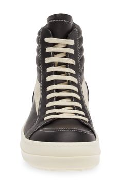 Crafted from full-grain leather and suede, this high-top sneaker is quintessentially Rick Owens with its blunted toe, dramatic lacing and shark-tooth sole. Drawing inspiration from vintage silhouettes and color schemes, this boldly topstitched shoe blends modern comfort with a timeless aesthetic. Lace-up style Leather upper and lining/rubber sole Made in Italy Designer Shoes Lace-up High-top Sneakers In Calf Leather For Streetwear, Lace-up High-top Calf Leather Sneakers For Streetwear, Black Calf Leather High-top Sneakers For Streetwear, Sporty Calf Leather High-top Sneakers, Calf Leather Lace-up High-top Sneakers, Lace-up High-top Calf Leather Sneakers, Calf Leather High-top Sneakers With Abzorb Midsole For Streetwear, Designer Calf Leather High-top Sneakers For Streetwear, Designer Leather High-top Sneakers For Streetwear