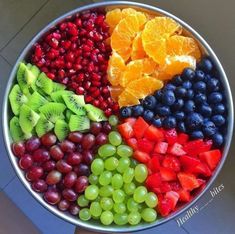 a large metal bowl filled with lots of fruit