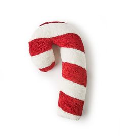 a red and white candy cane shaped pillow on a white background with copy space for text