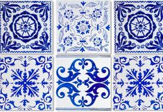 four blue and white tiles with different designs on each tile, one in the shape of an ornament