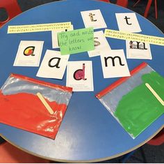 a blue table topped with lots of different types of paper and magnets on top of it