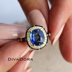 "ITEM DETAILS: This designer ring features a GIA certified 3.87ct blue sapphire center stone, assented with a matching transparent blue enamel which highlights a reflection of the 18K solid gold metal underneath. To add some contrast to the blue tone of the ring, we set 24 genuine diamonds around the sapphire, 8 genuine diamonds on the sides of the halo, and 2 on its shank. Item#: SAPR221 Metal: 18K Solid Gold Center-stone Shape and Type: Oval, GIA Certified Natural Corundum Sapphire  Center Stone weight: 3.87ct GIA-certified Center Stone dimensions: 10.06x8.58x4.52mm Center Stone treatment: Beryllium Diffused Center Stone style: brilliant cut at the crown, step cut at the pavilion Diamond Shape: Round-cut Diamond Count: 34 (24 around the center stone, 10 on halo sides and 2 on the shank) Luxury Gold Domed Sapphire Ring, Luxury Gia Certified Lab-created Sapphire Jewelry, Luxury Royal Blue Sapphire Round Ring, Luxury Royal Blue Sapphire Ring, Luxury Blue Sapphire Ring Gia Certified, Luxury Royal Blue Sapphire Ring With Diamond, Luxury Gia Certified Blue Sapphire Ring, Luxury Gia-certified Blue Sapphire Ring, Luxury Blue Sapphire Ring With Diamond Accents