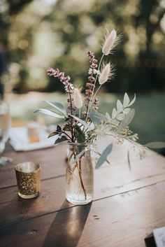 a vase filled with flowers sitting on top of a wooden table