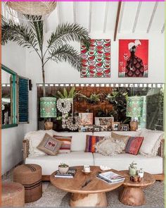 a living room filled with lots of furniture and plants on top of it's walls