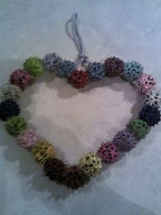 a heart shaped ornament made out of small flowers