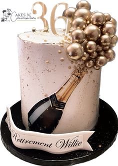 a birthday cake decorated with champagne and pearls