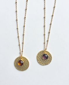 Hammered Gold Disc With Gem. This hammered disc necklace features your choice of amber or purple crystal charm. The necklace is made with a beautiful gold-filled satellite chain and finished with a gold-filled lobster clasp. The hammered discs are gold-plated brass and measure 20 mm. The crystal charm measures 9 mm and is framed with gold electroplating. Your necklace will arrive in a gift box. If this is a gift, I would be happy to include a card with your personal message - just let me know in Gold Metal Round Crystal Necklace, Gold Metal Crystal Necklace, Hammered Spiritual Necklaces With Adjustable Fit, Hammered Amulet Coin Necklace Gift, Hammered Amulet Style Coin Necklace Gift, Adjustable Hammered Spiritual Necklaces, Hammered Amulet Coin Necklace As Gift, Spiritual Hammered Round Necklace, Spiritual Hammered Adjustable Necklace