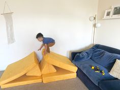 a young boy is playing on an inflatable bed that's shaped like a plane